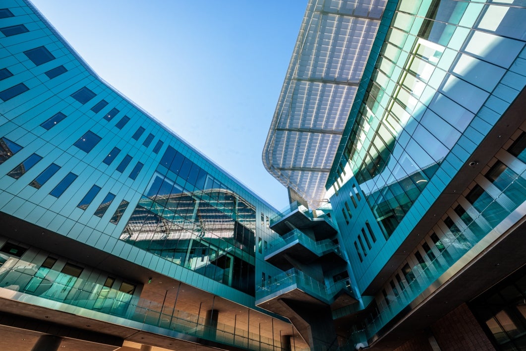 An angled, artistic photo of the glass-encased interior courtyard of ISTB7