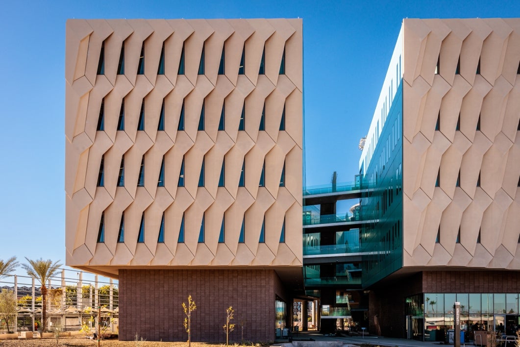 An exterior photo of the ISTB7 building, showing the glass-rich courtyard glimpsed between two larger blocks of building