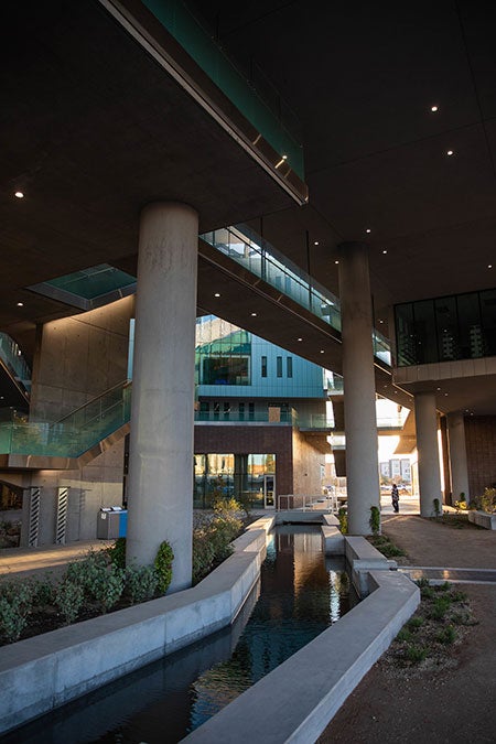 A canal cuts through a building courtyard