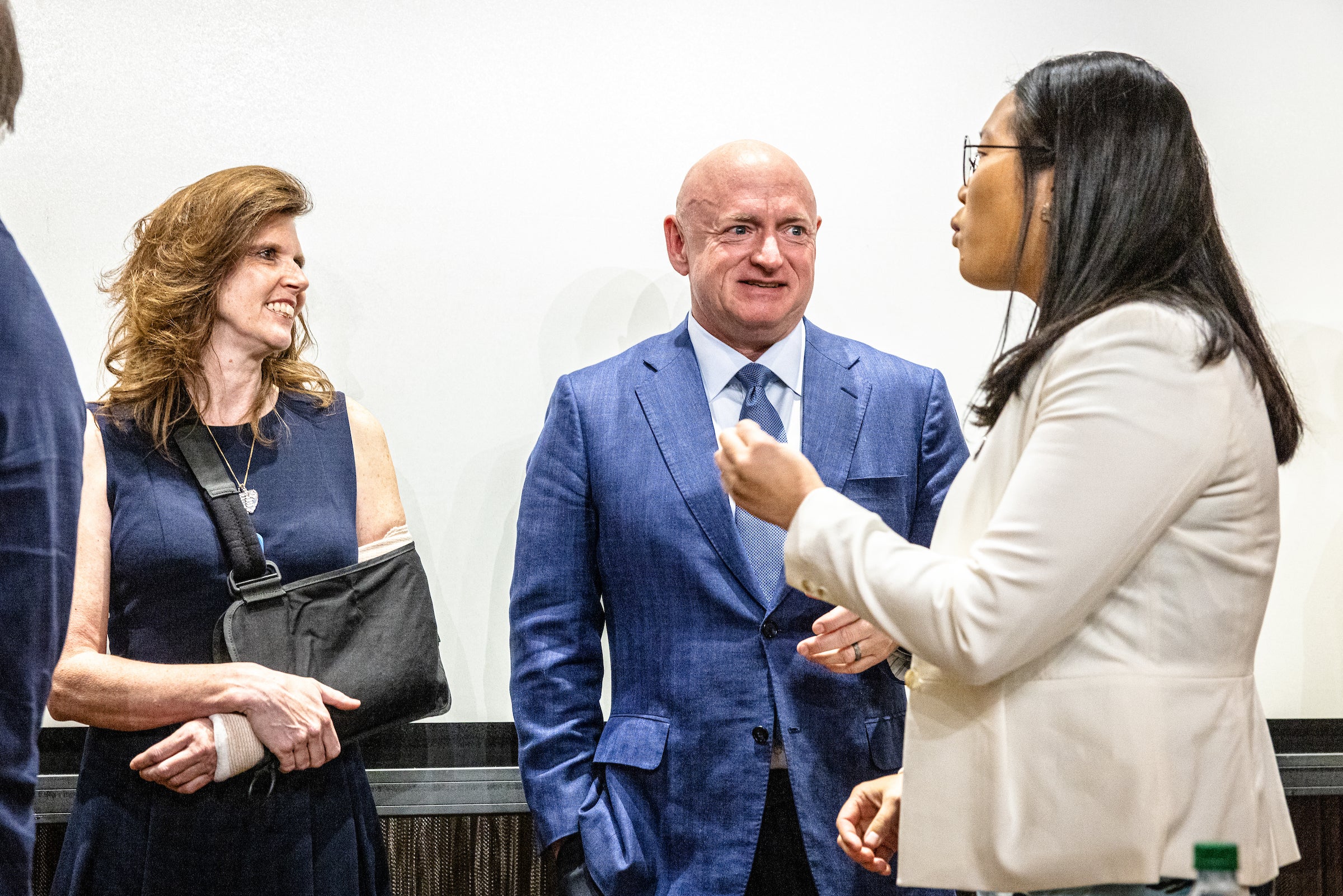 three people talking after event