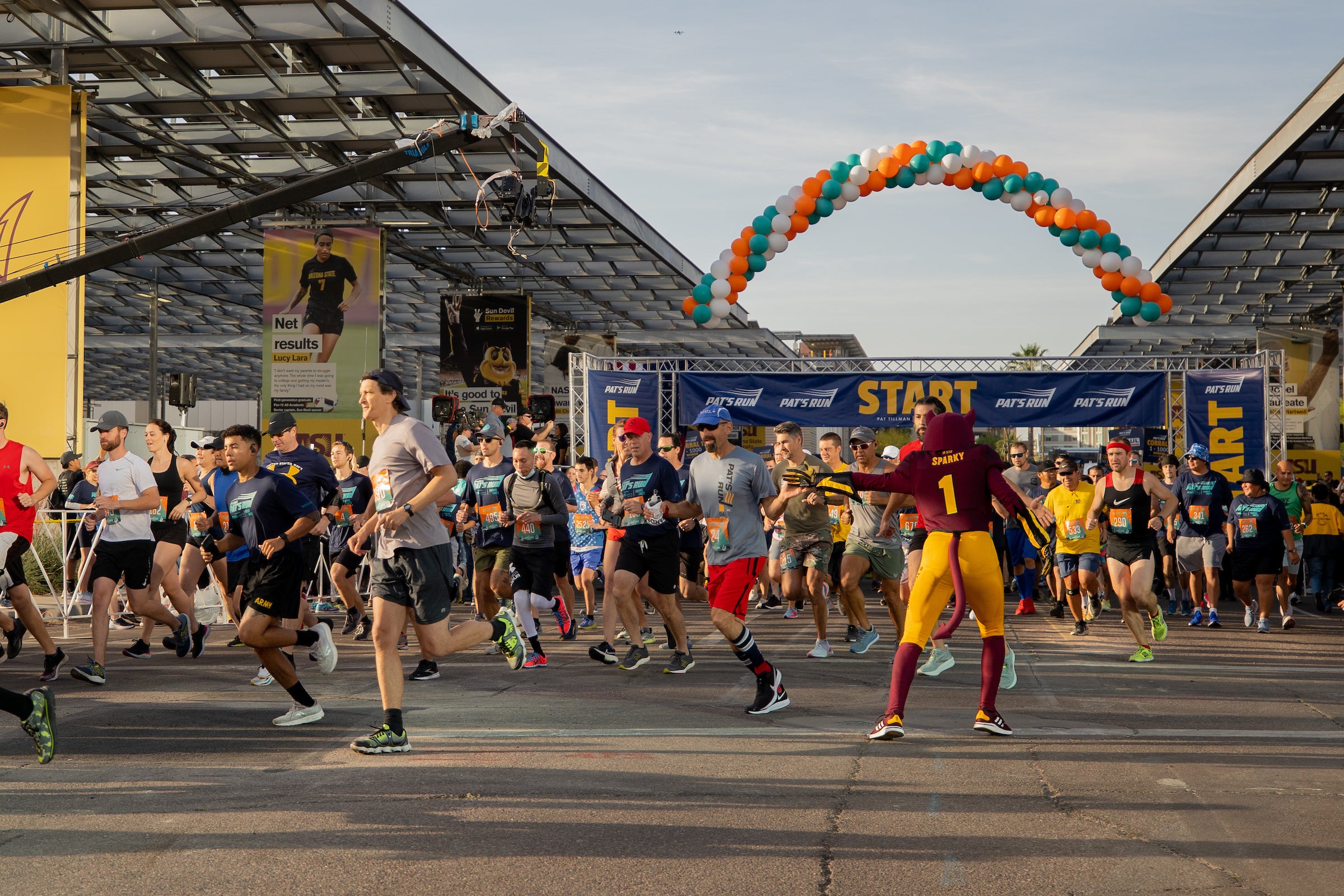 Sparky mascot directing runners at the start line