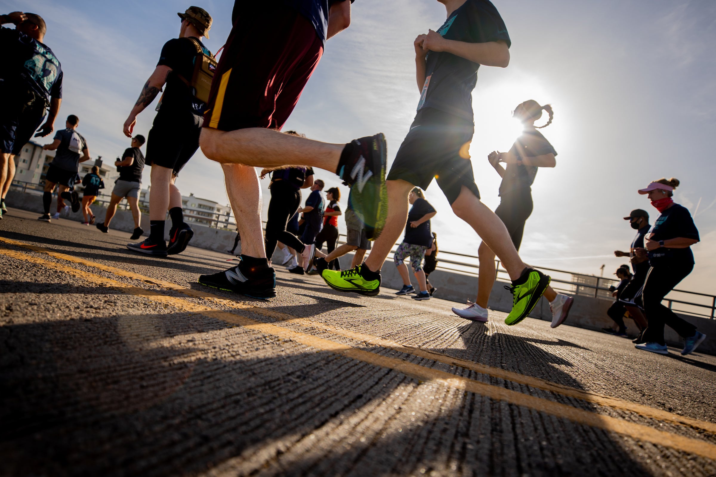 View of runners feet crossing Rural Road bridge