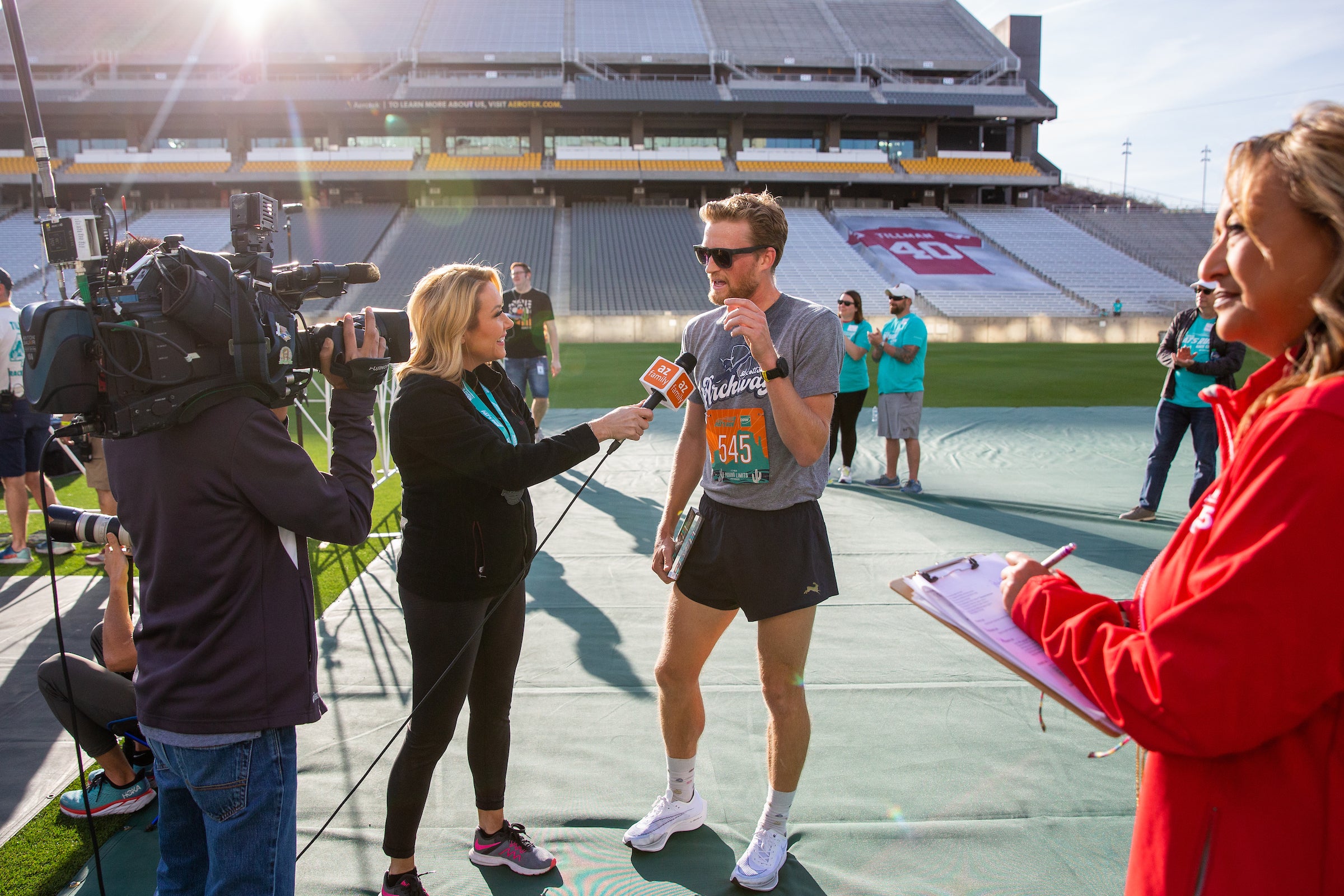 man talking to camera crew after Pat's Run