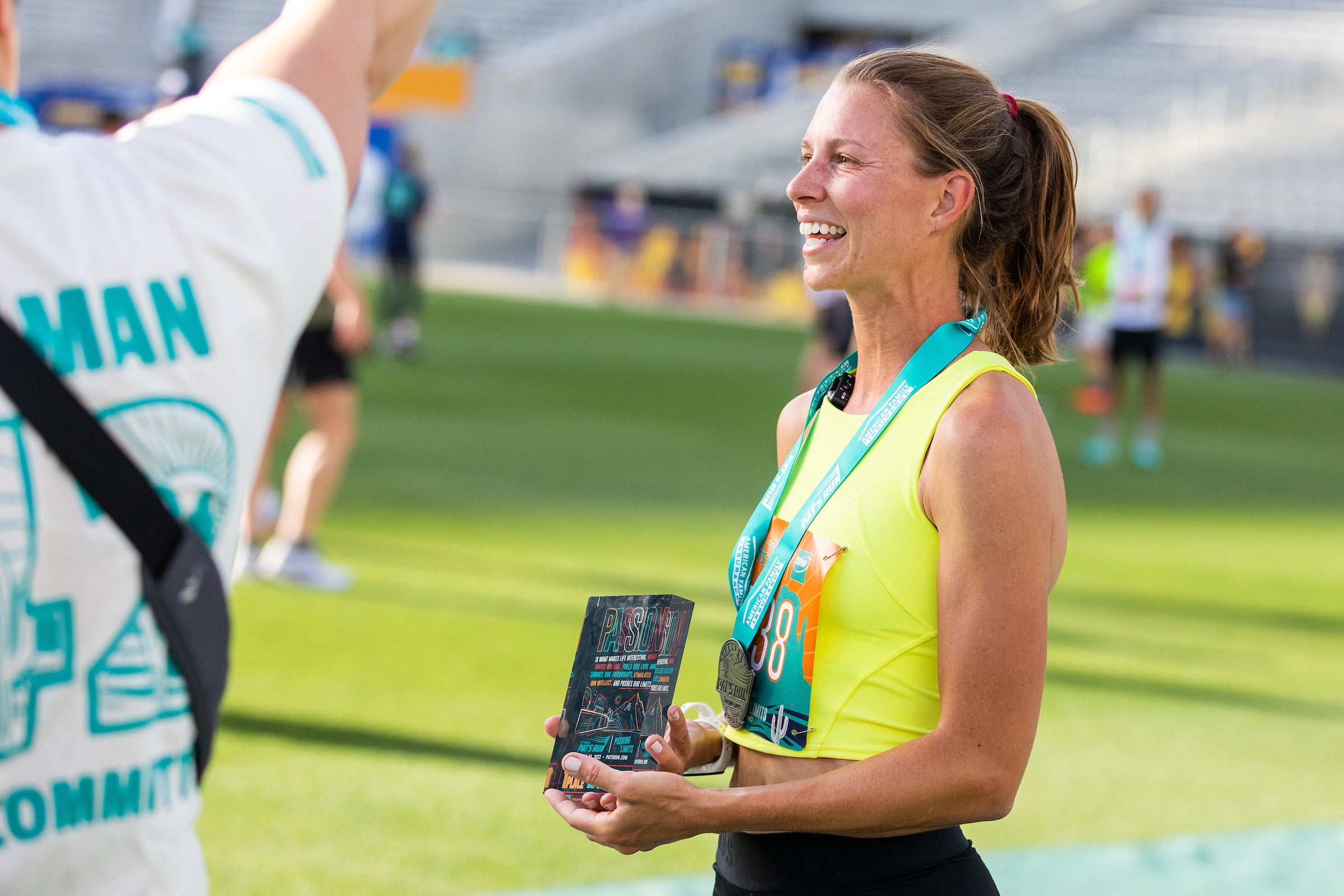 female racer holding award