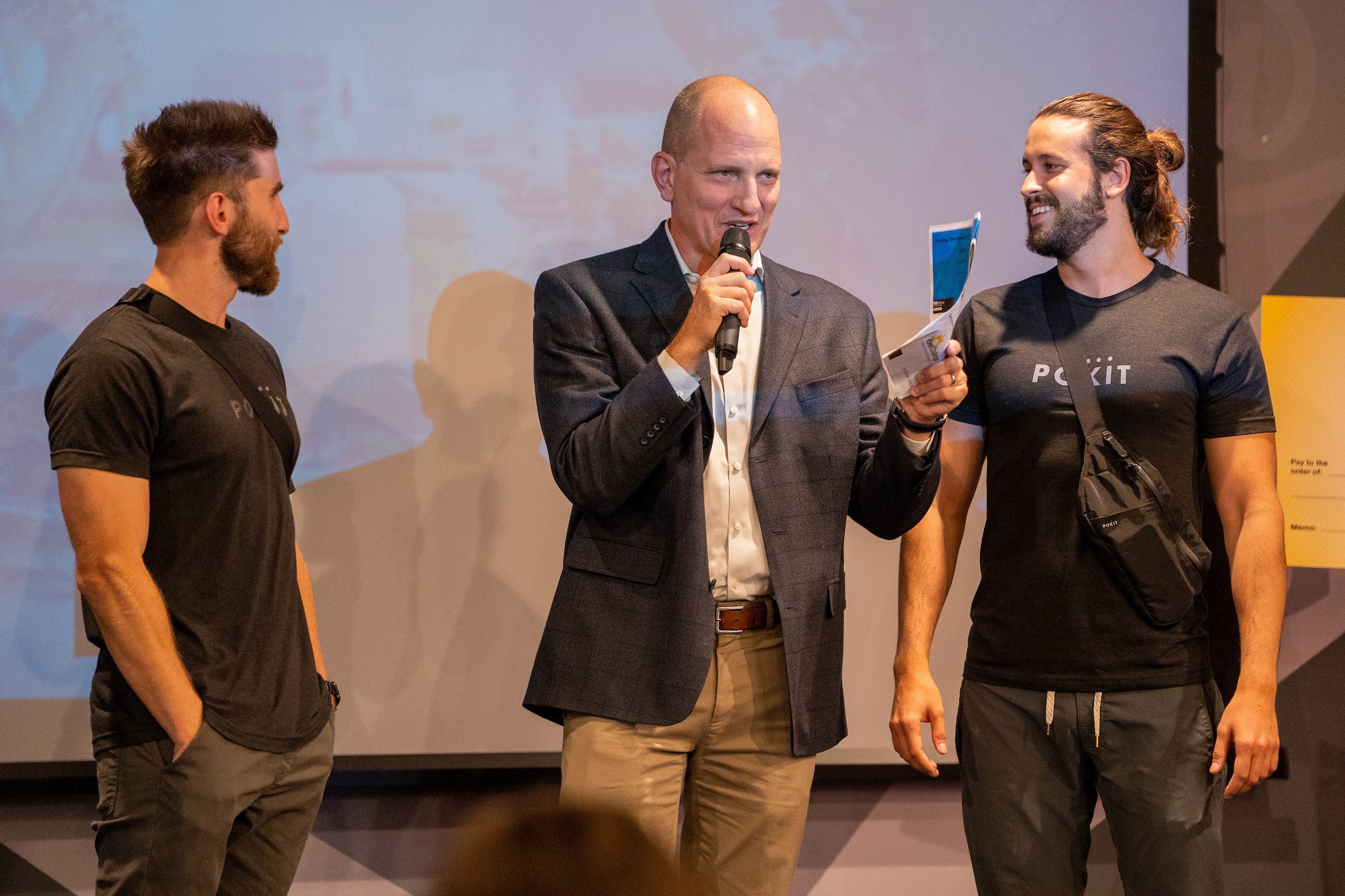 Three men on stage during Venture Devils event