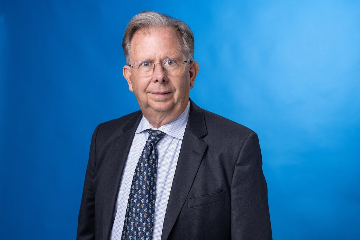 Man in blue suit and tie smiling