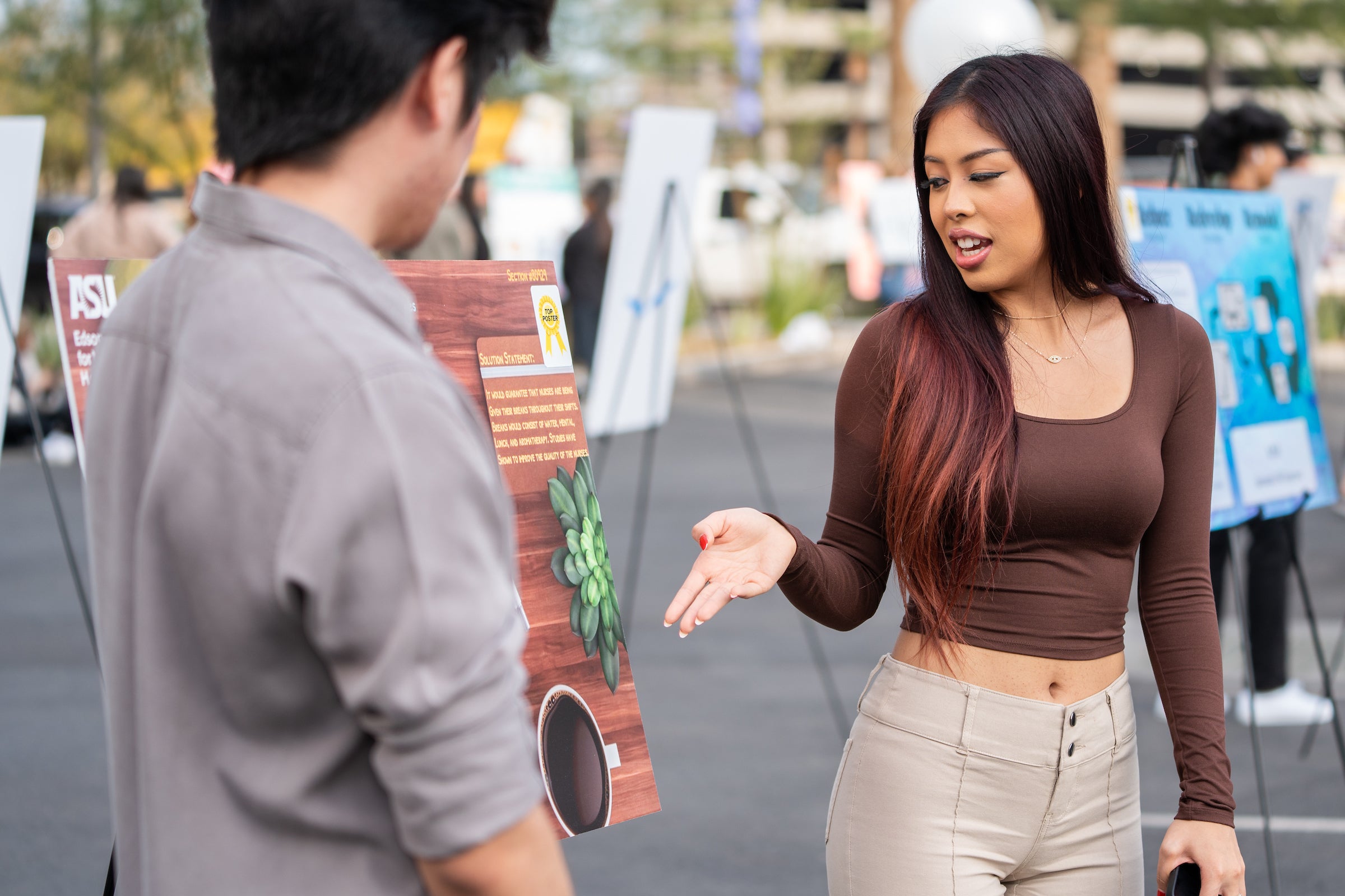 Two people talking about poster presentation