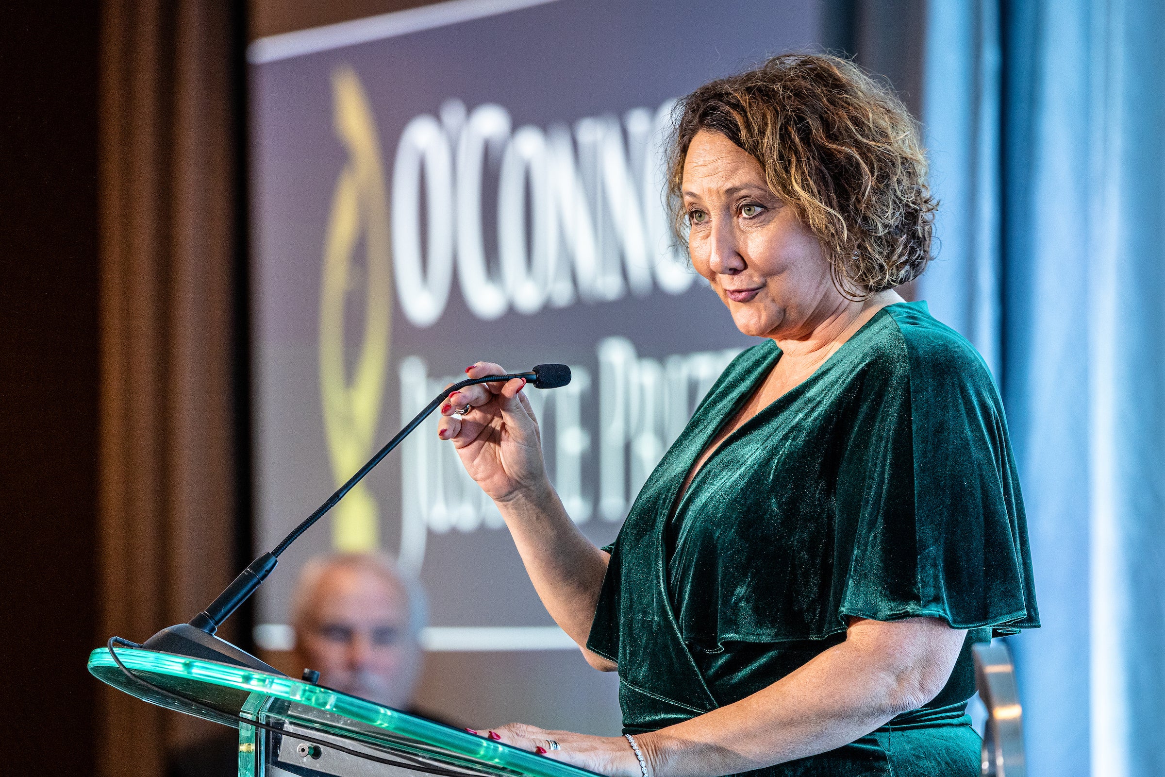 Woman speaking at lectern during event