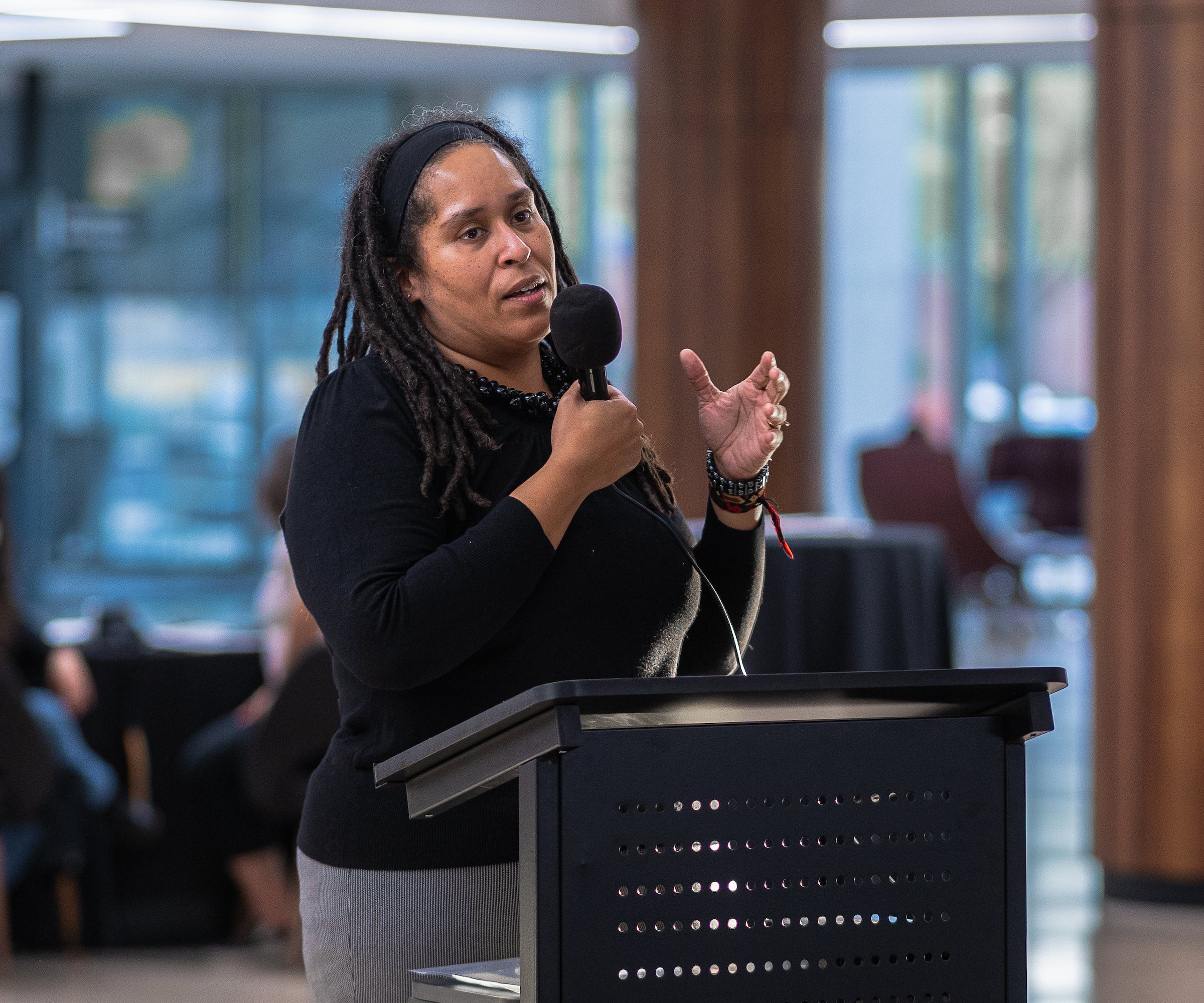 Woman speaks at lectern at event