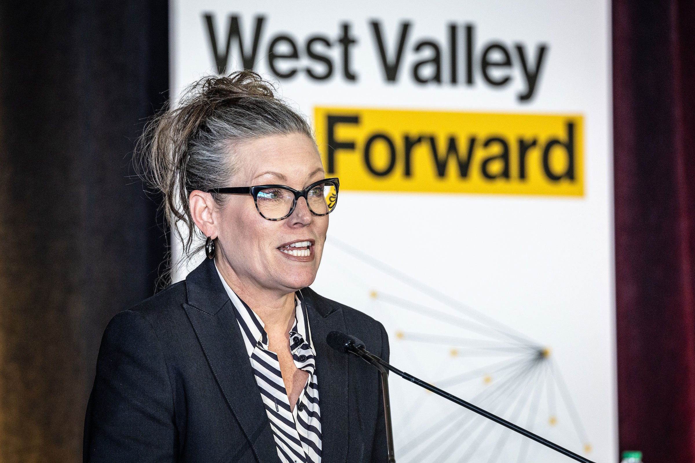 A woman speaks at a lectern