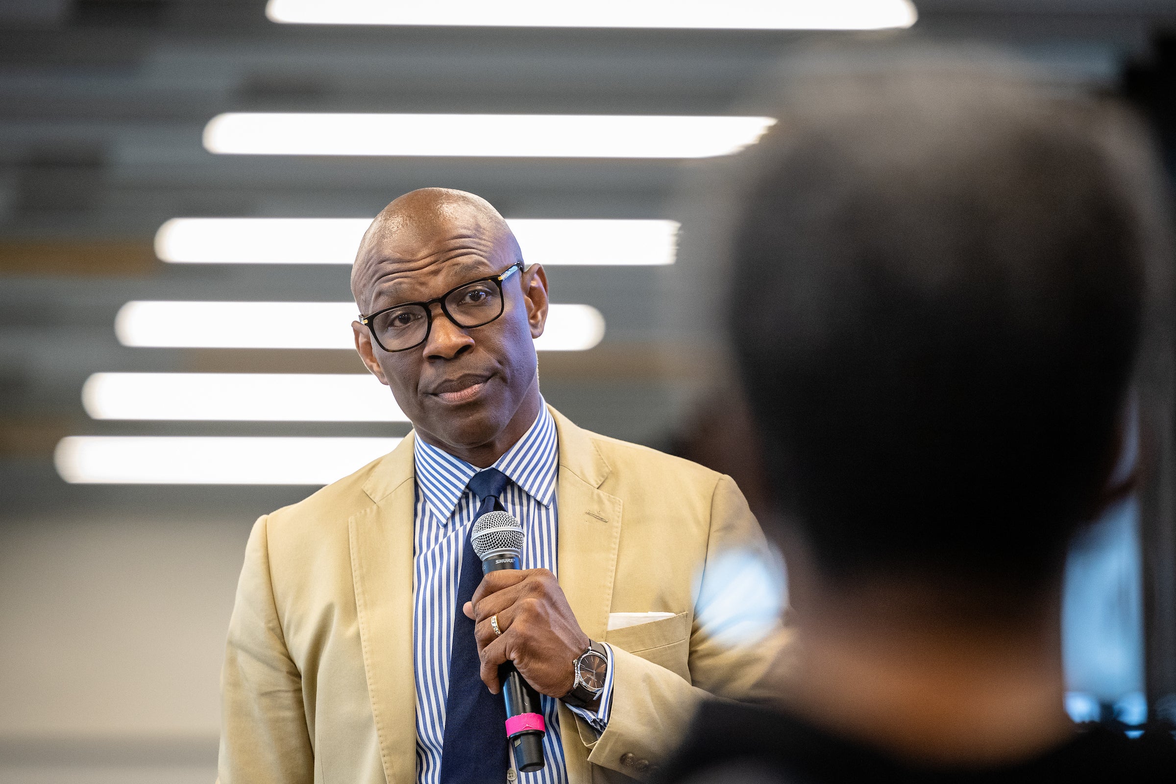 Man listening to woman ask a question during event