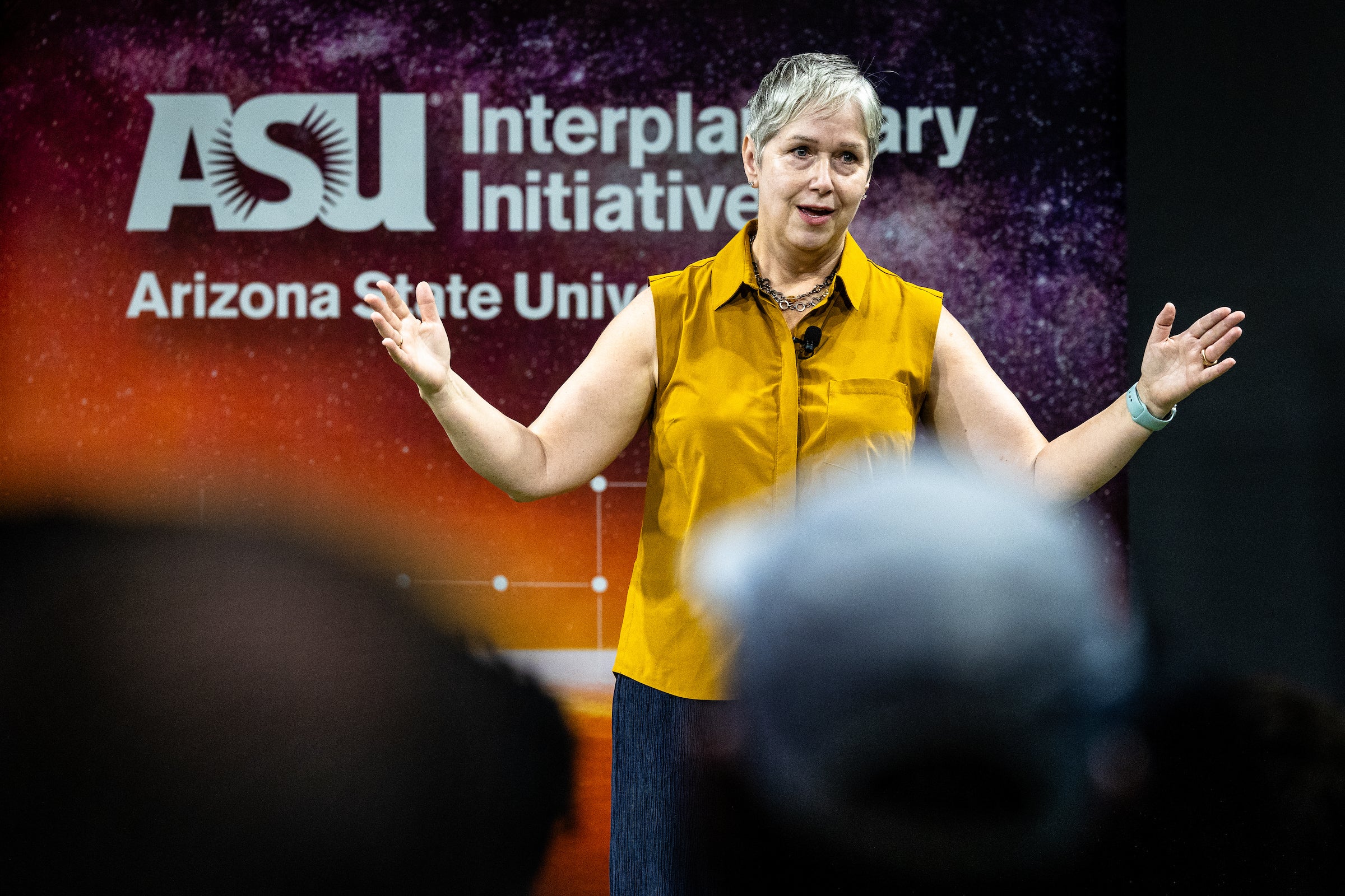 Woman speaking to audience at event