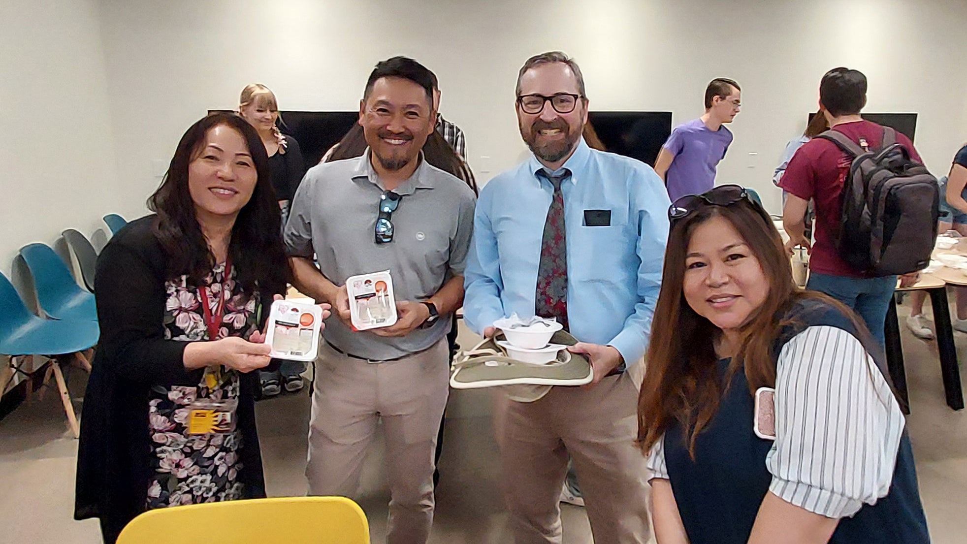 Group of four people smiling for camera at onigiri event