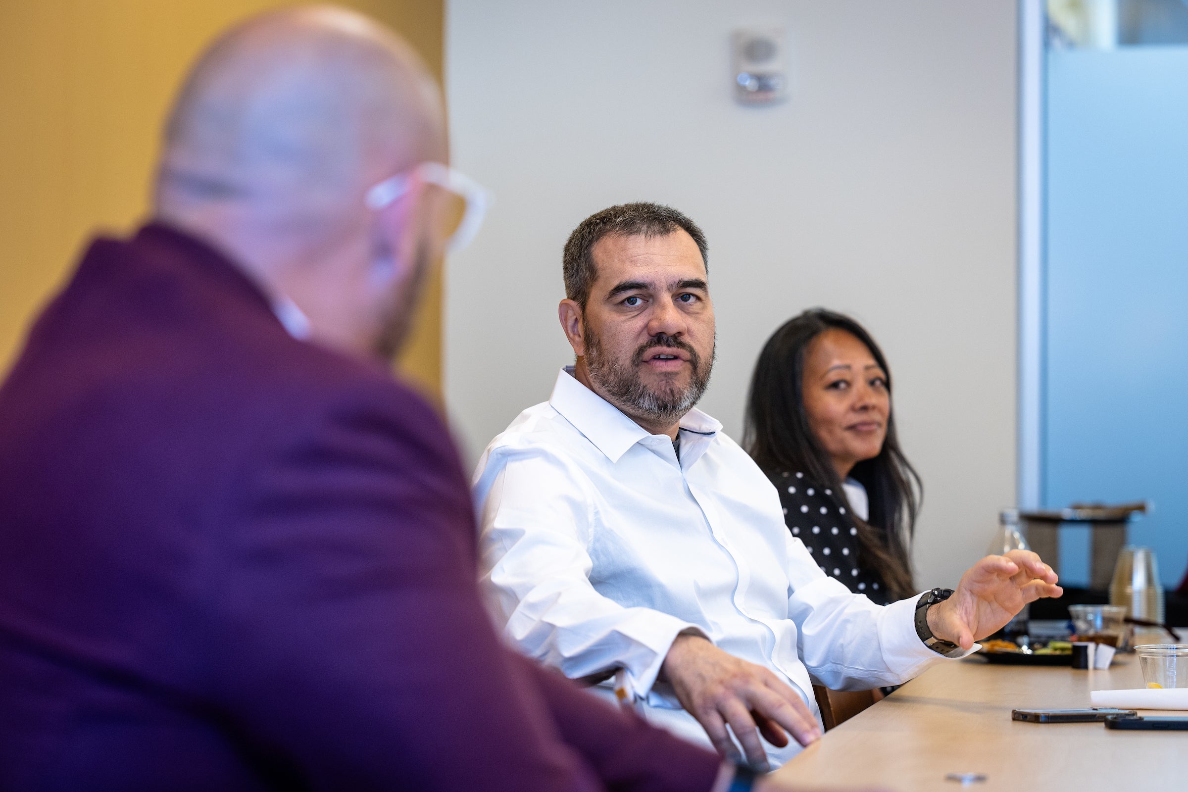 Man sitting at table speaking during meeting