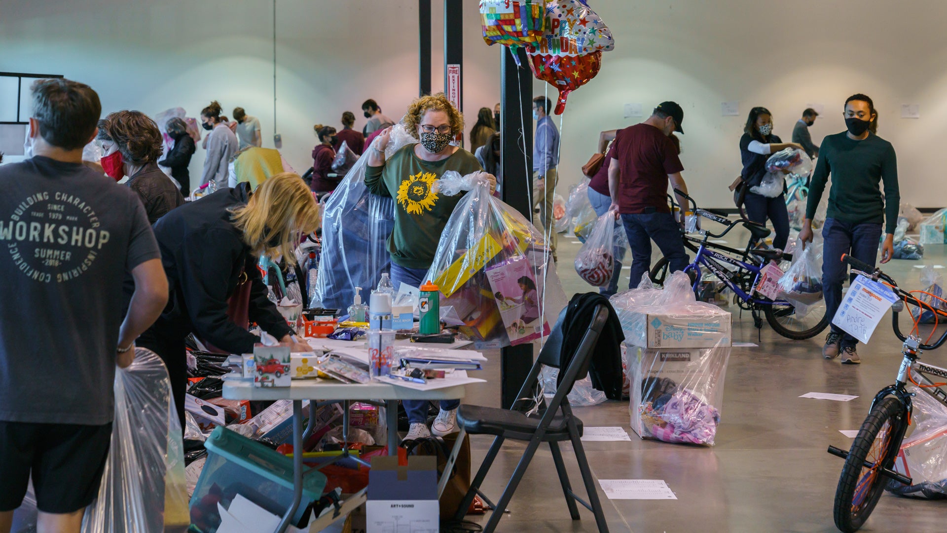 volunteers help organize toys and other donated items