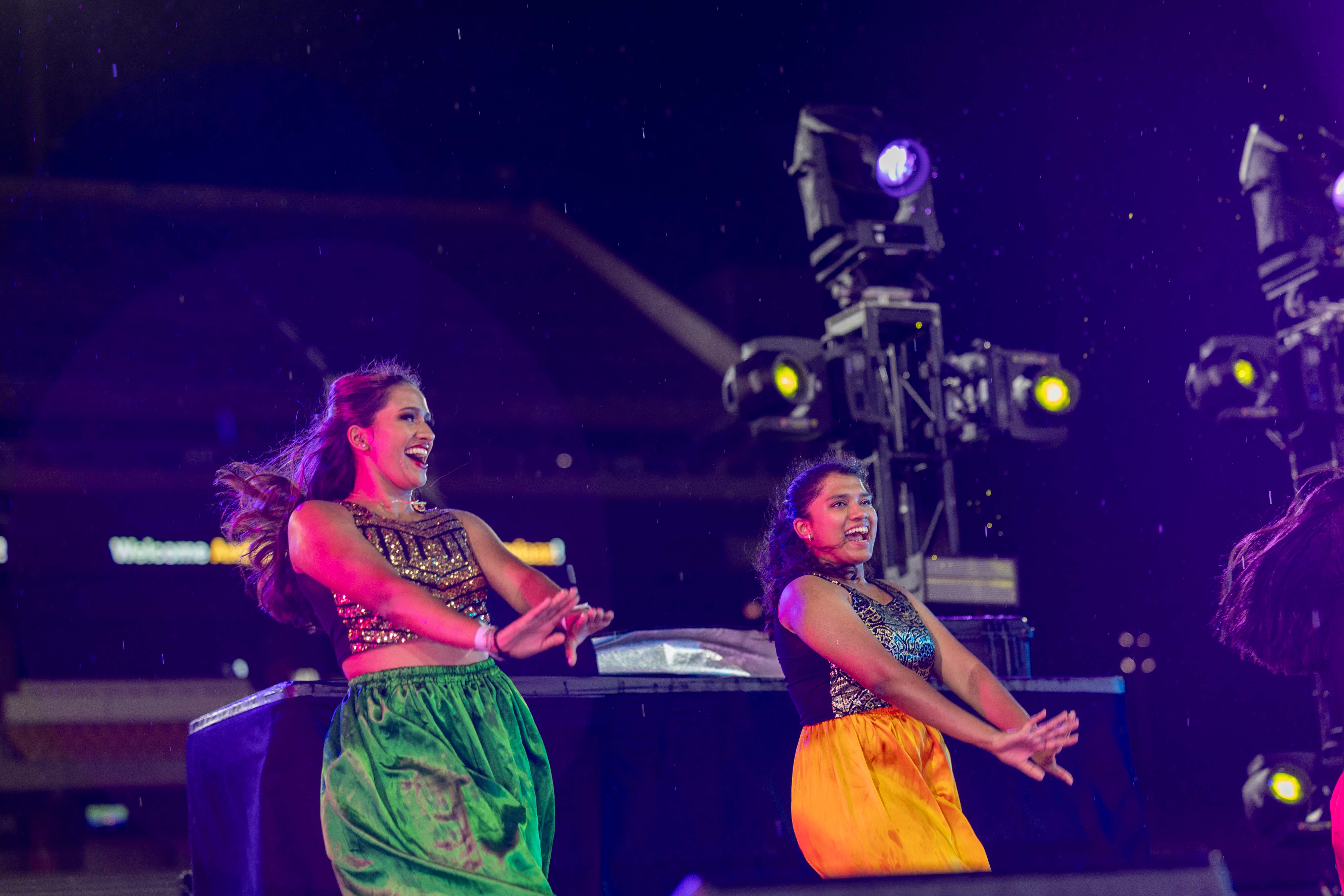 Two student dancers perform on stage