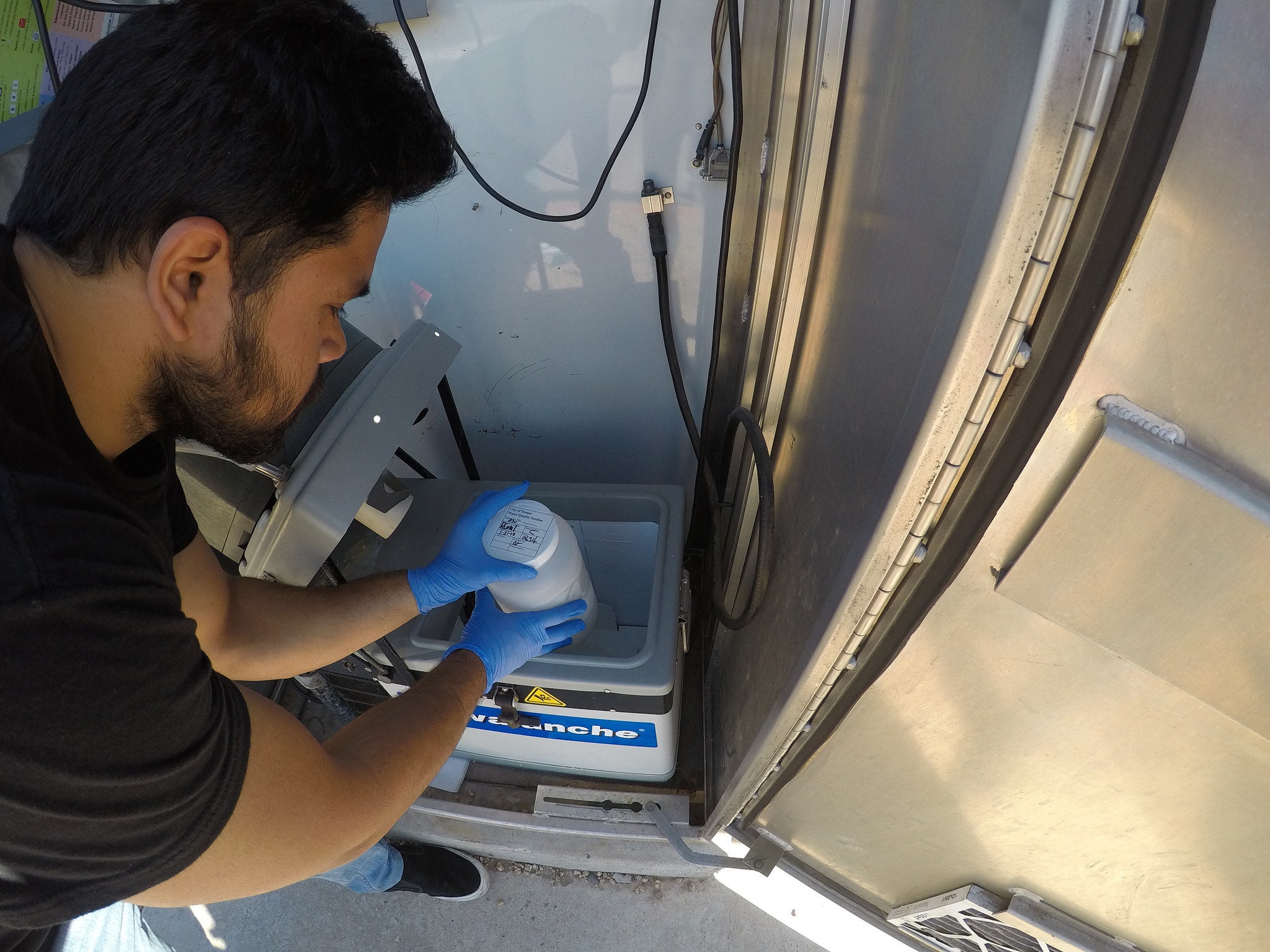 ASU PhD candidate Varun P. Kelkar examines a water sampling station