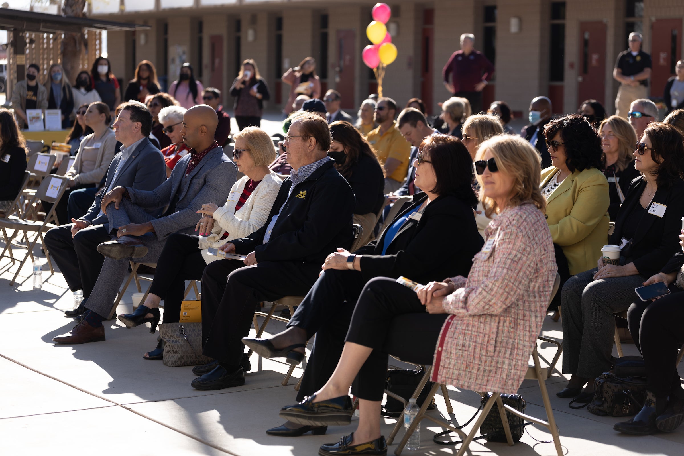 Audience sitting outdoors at event