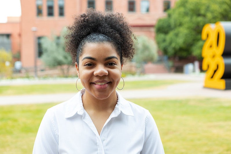 Graduating student poses for photo