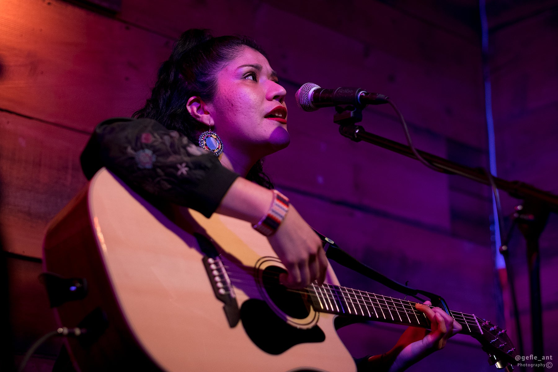 Woman strumming guitar