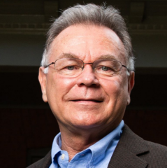 Portrait of man with short gray hair wearing glasses