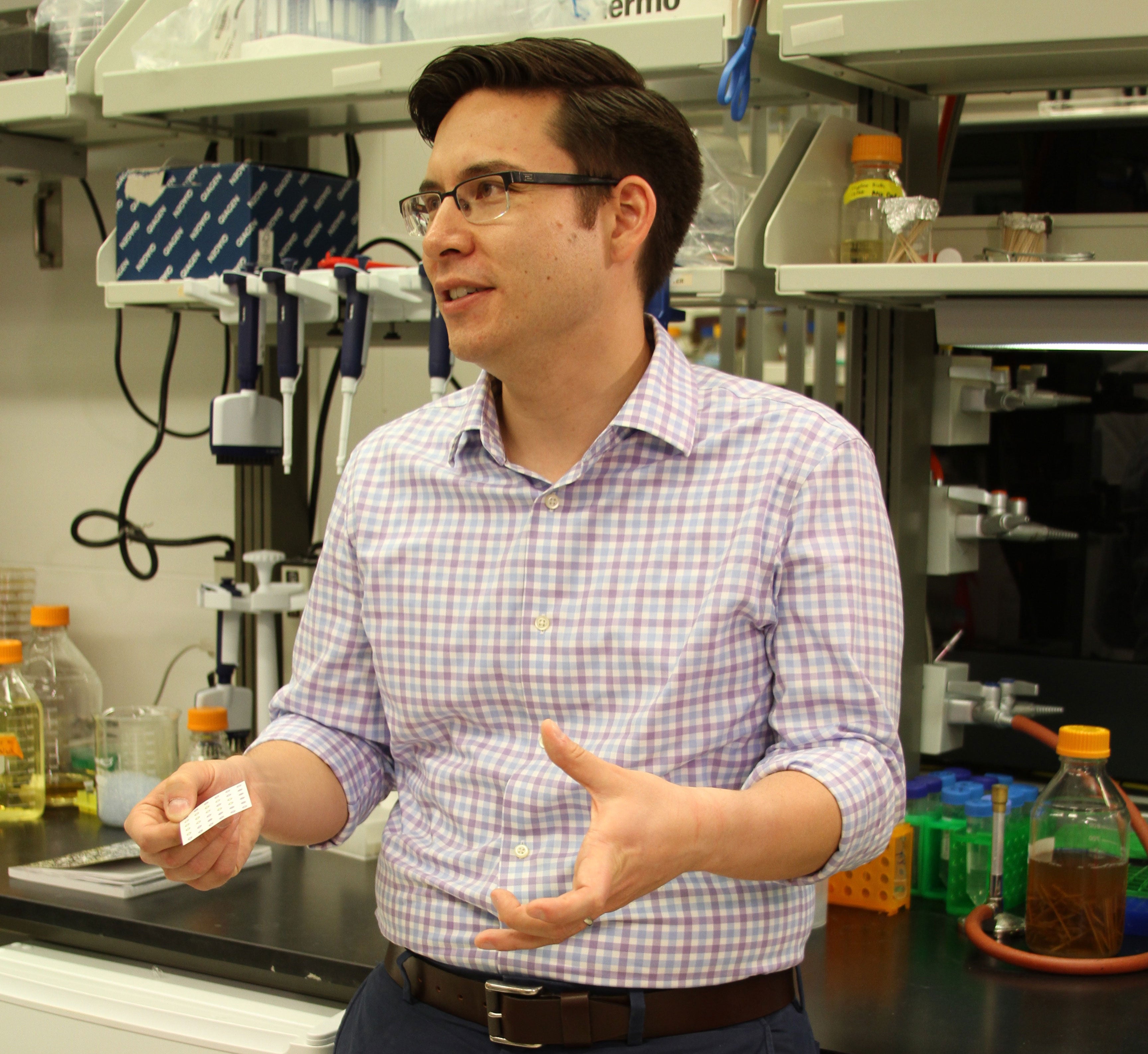 ASU professor Alexander Green talks in a Biodesign lab.