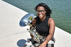 woman holding tuba