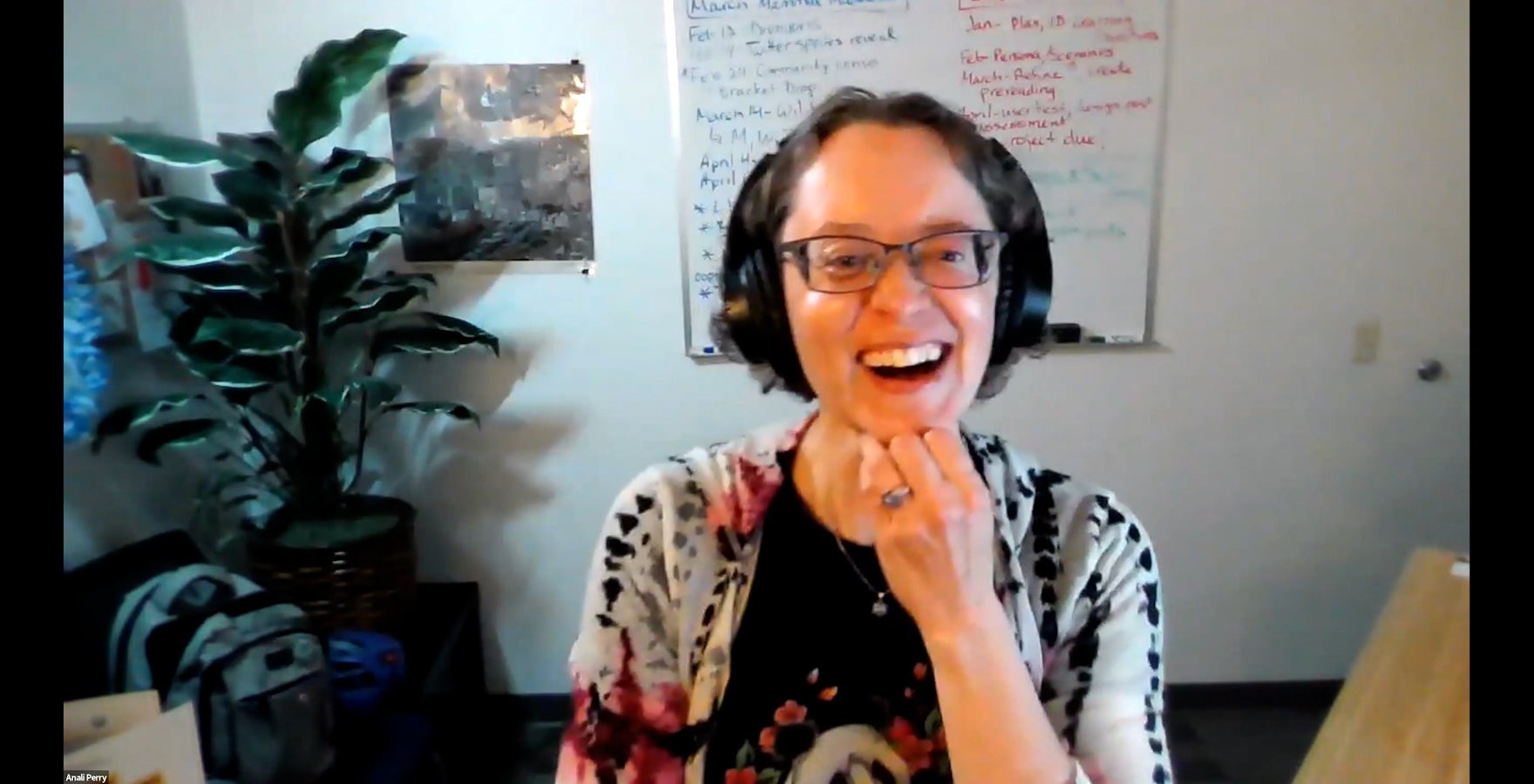 Woman with headphones in an office on a virtual meeting