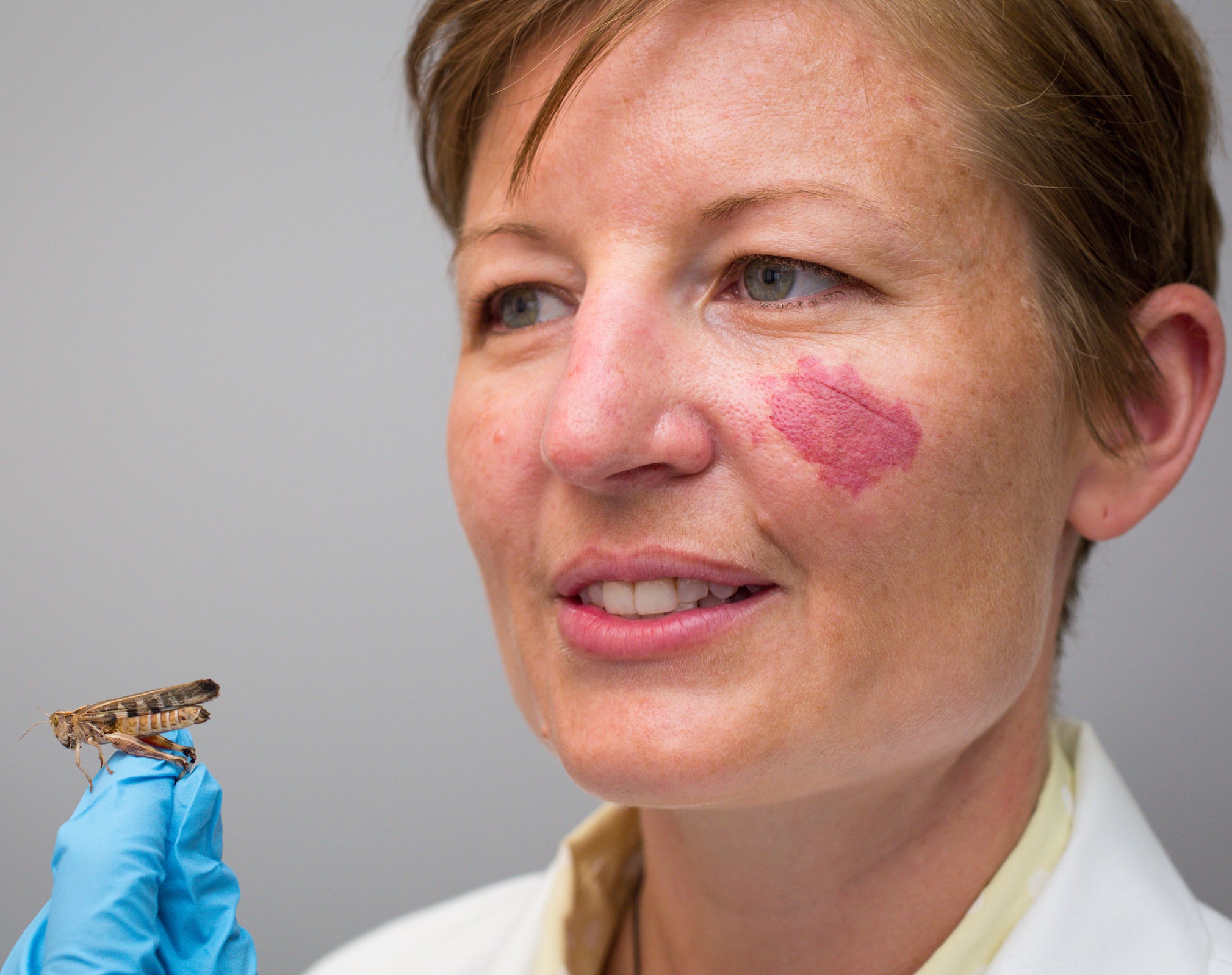 Lady holding a grasshopper