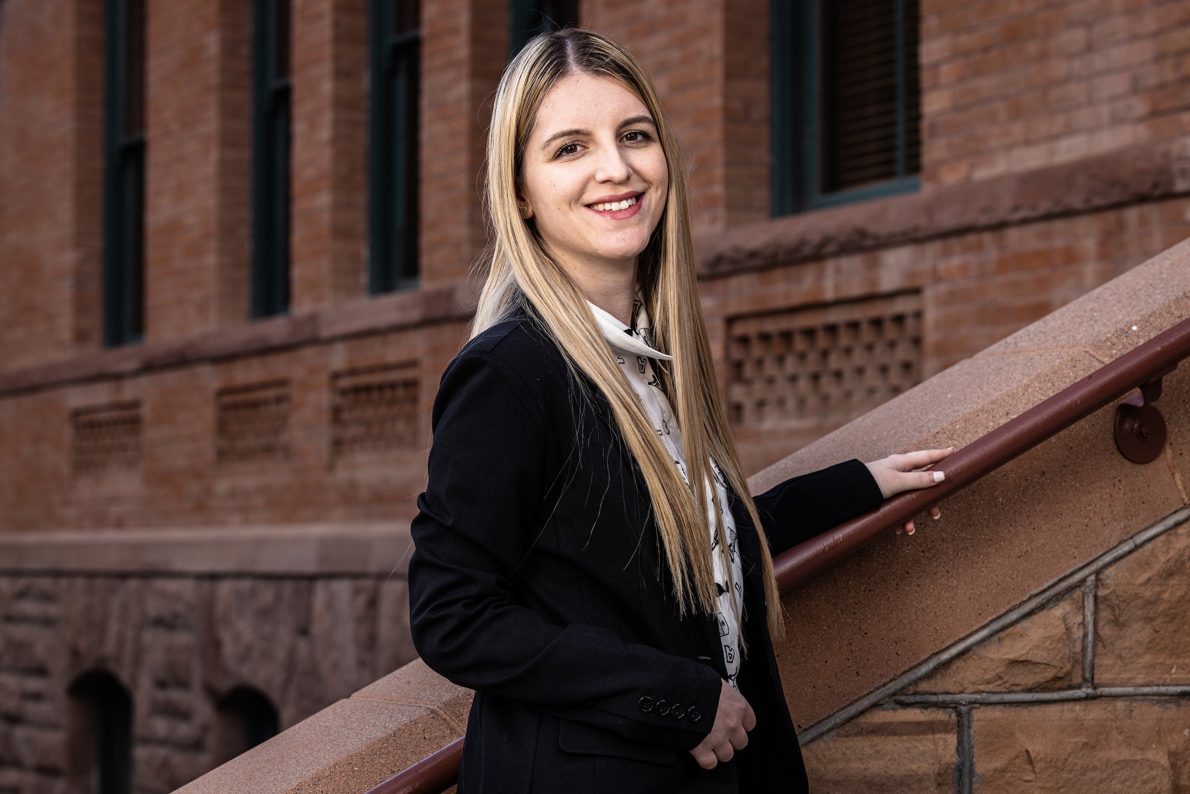 Student's portrait on Old Main stairs on Tempe campus