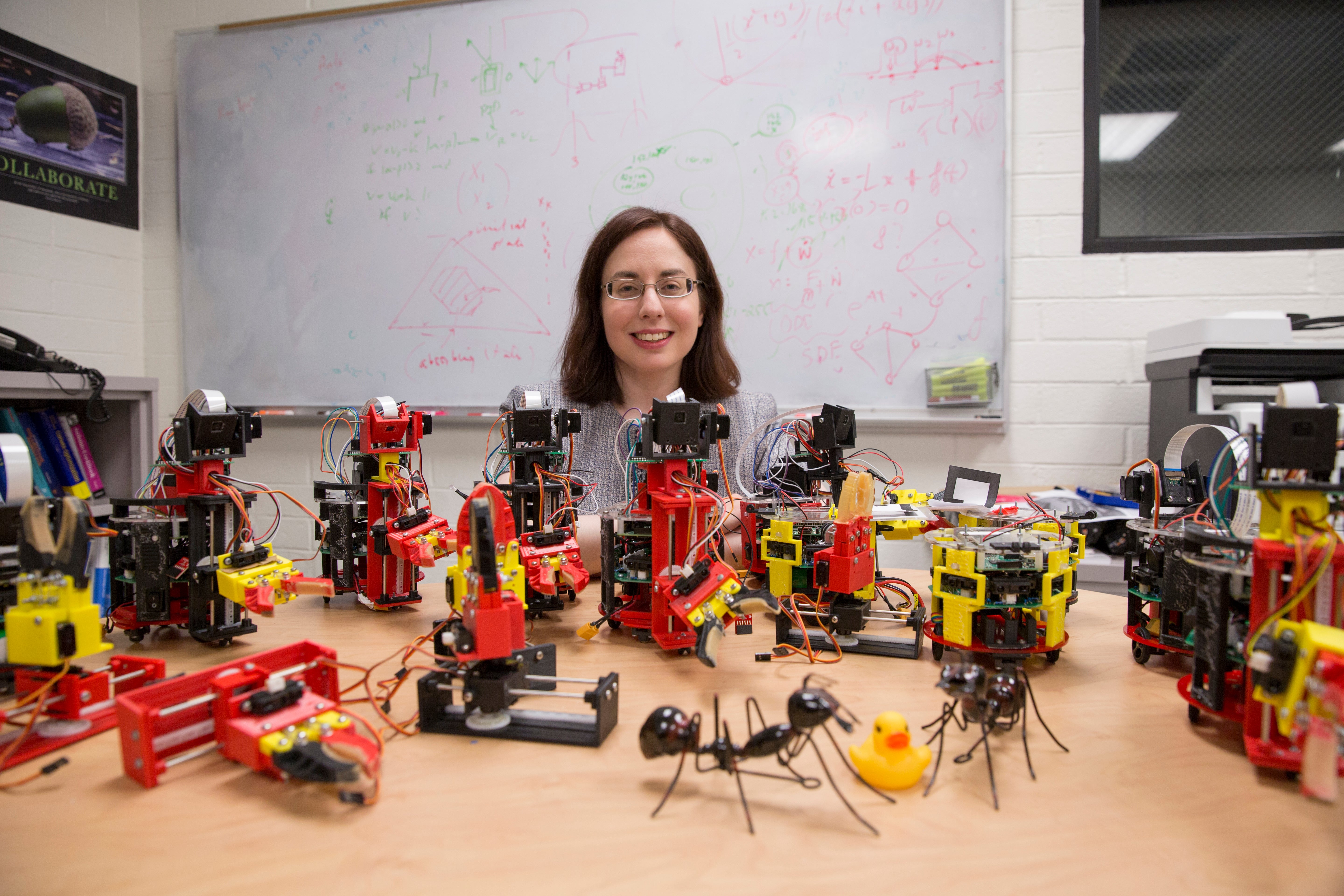 ASU engineer posing with bio-inspired robots