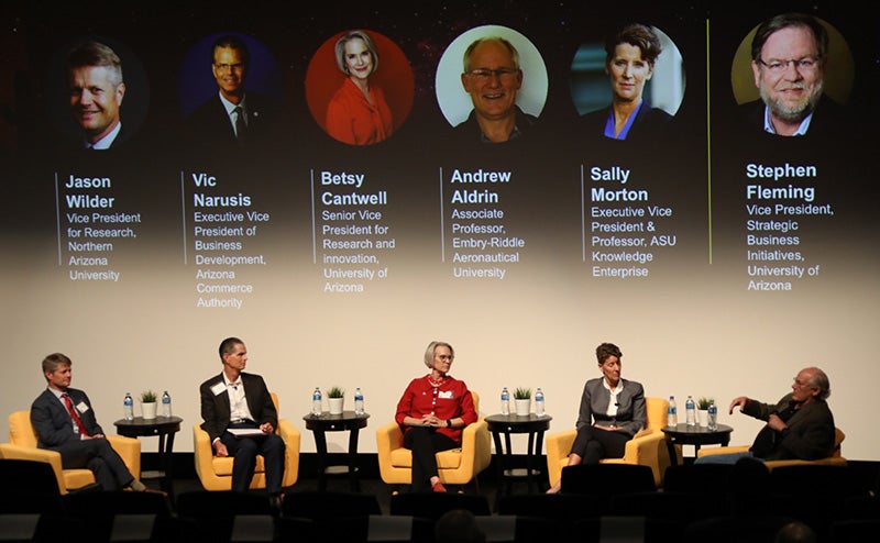  Panelists Jason Wilder, Vic Narusis, Betsy Cantwell, Andrew Aldrin, Sally Morton and Stephen Fleming sit on stage at the Arizona Space Summit.