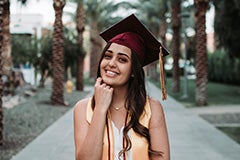 woman posing in grad cap on Palm Walk