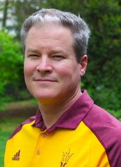 Man with gray hair and smiling