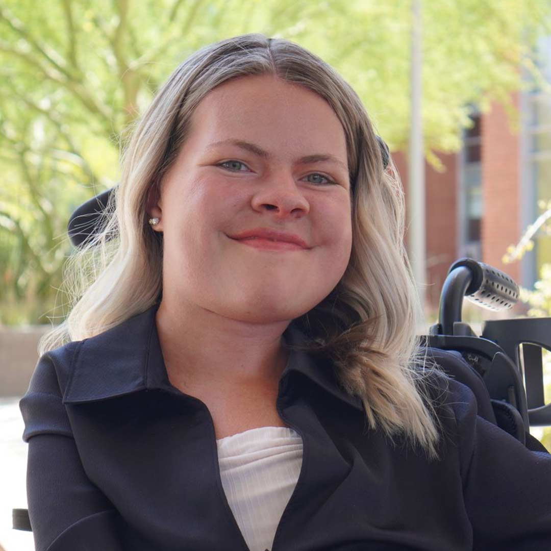 Undergraduate student  smiles at the camera.