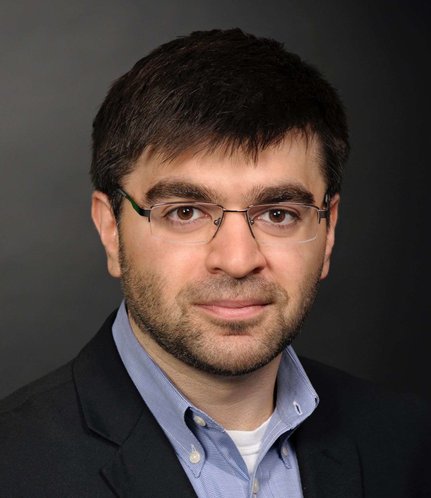 Man in glasses and open collar shirt