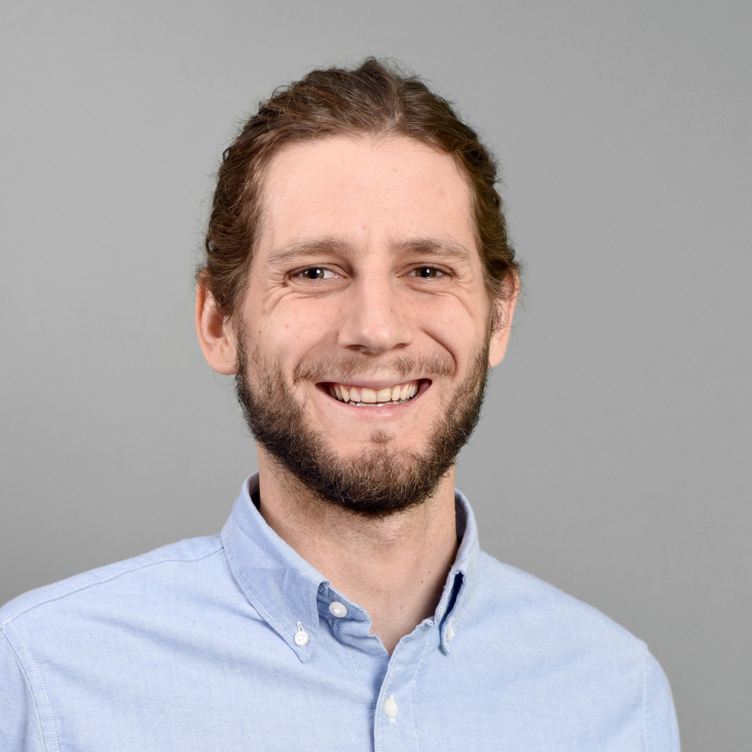 Man with pulled back hair and beard