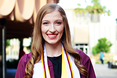 woman posing in graduation gown