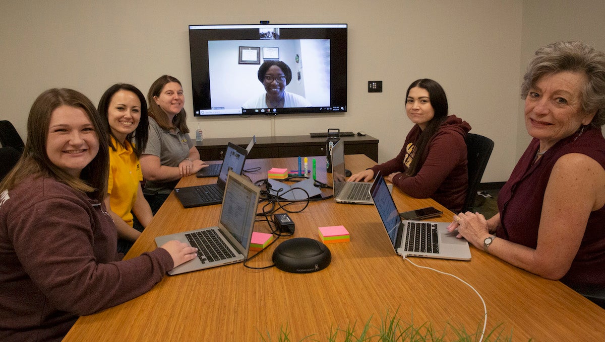 five women sitting around a conference table