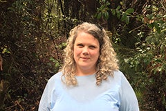 woman standing in woods