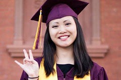 student in graduation cap and gown flashing pitchfork