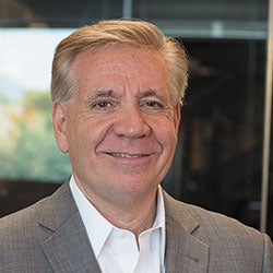 Man with gray hair and smiling