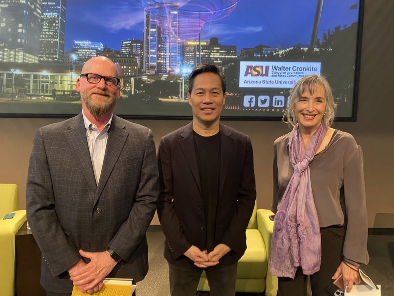 From left to right: David Coon, Richard Lui and Julia Wallace pose for a group photo in a lecture hall.