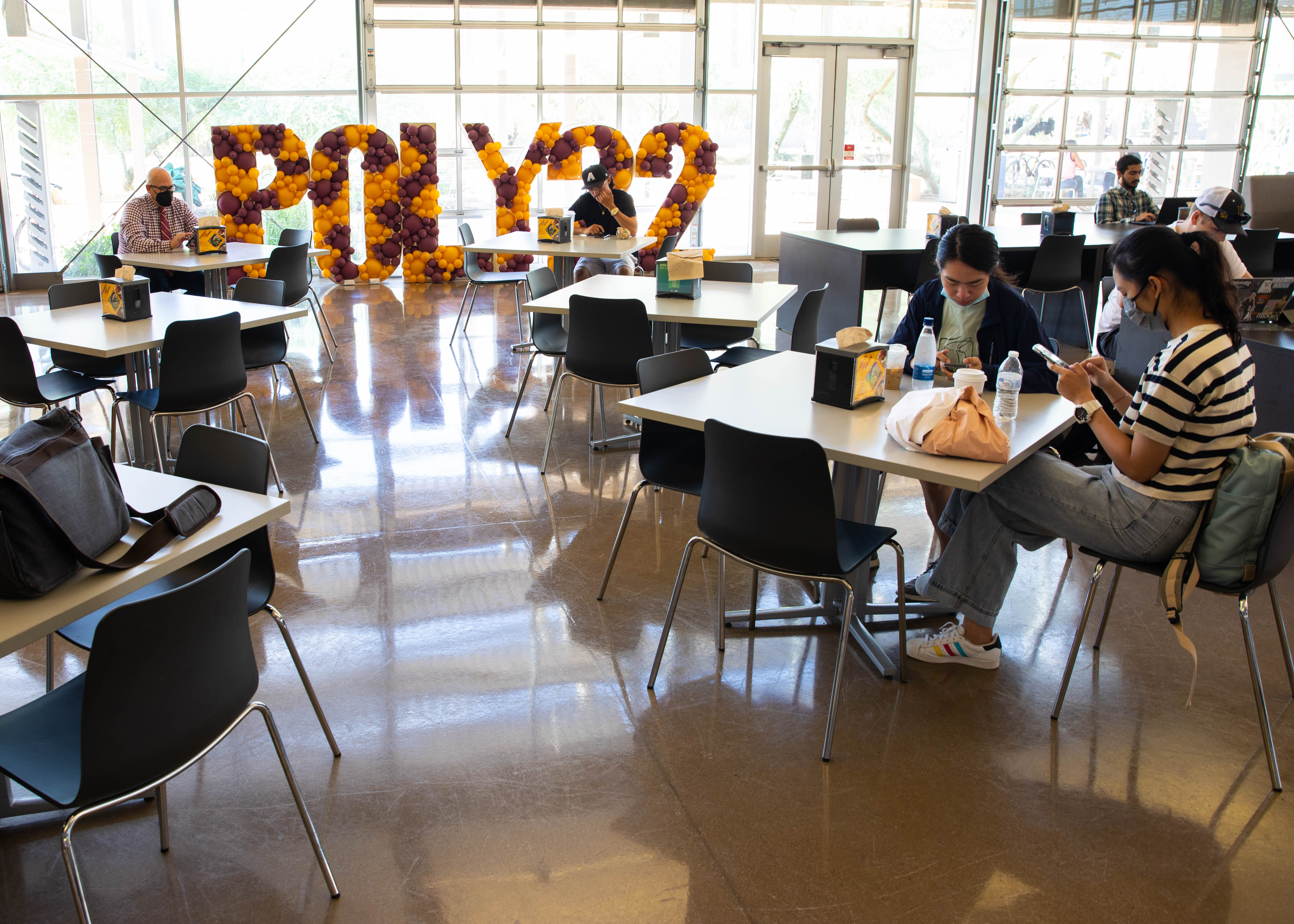 Student sitting in Student Union at ASU Polytechnic campus