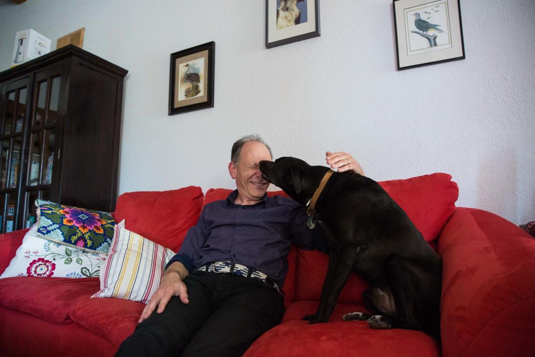 man and dog on couch