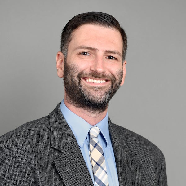 Man in beard and suit smiling