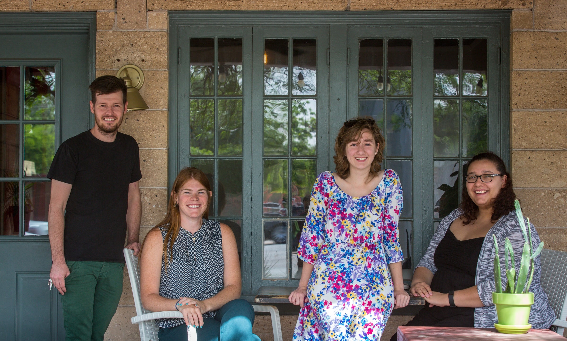 Students and a chef on a front porch.