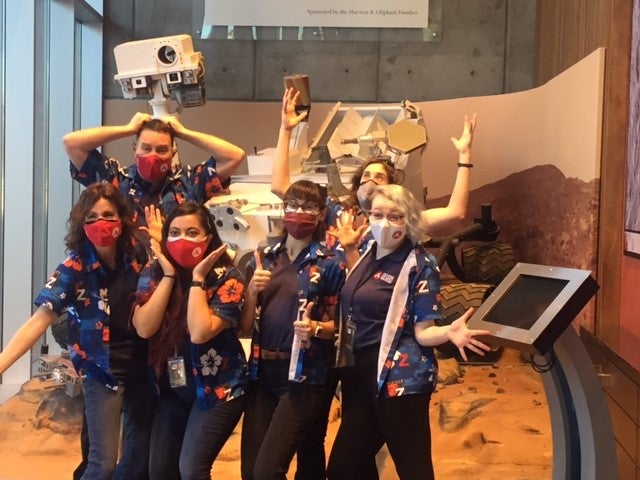 Team posing in front of replica of Mars rover