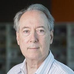 Man with grey hair and striped shirt