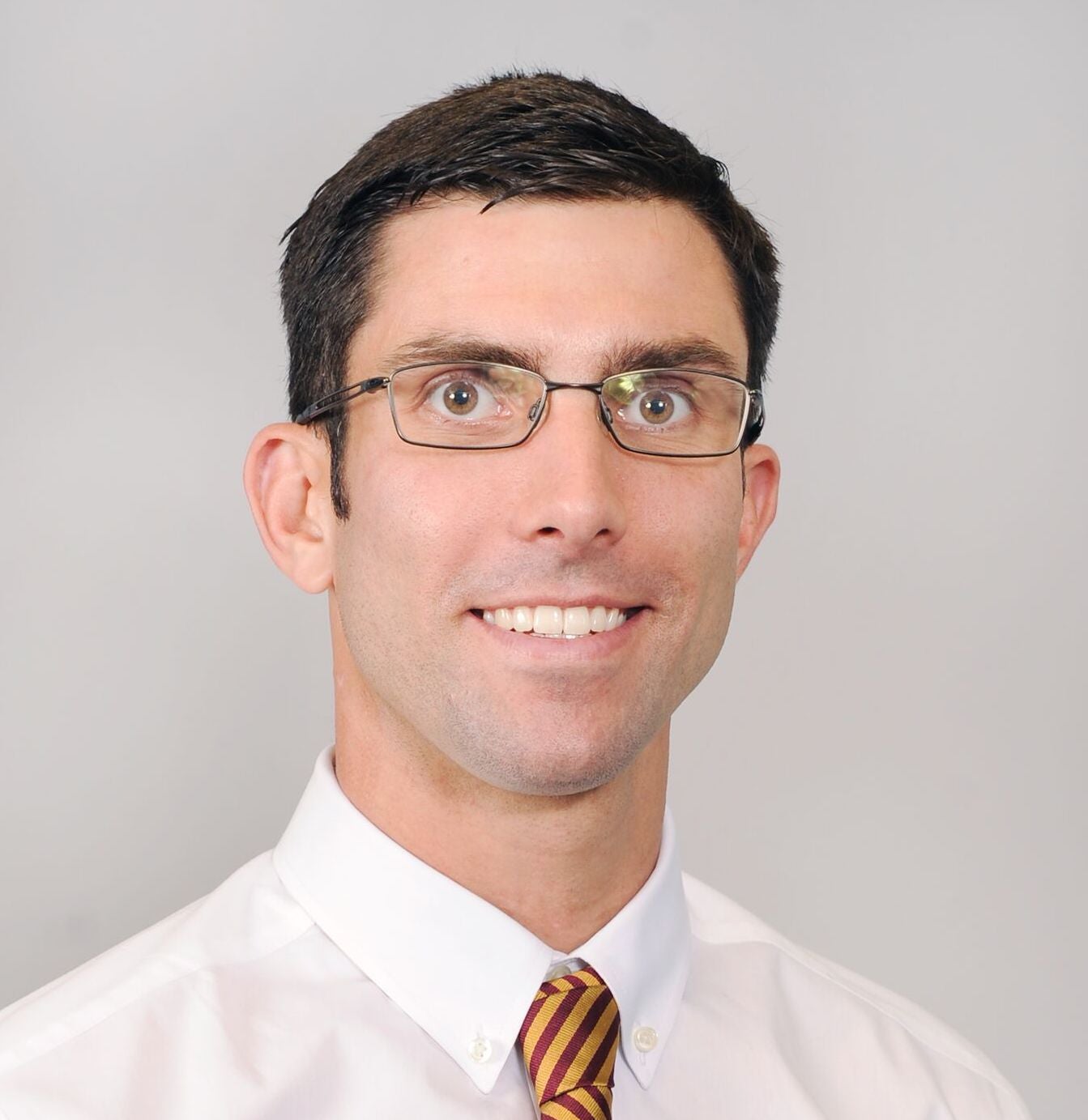 Man in glasses and tie smiling